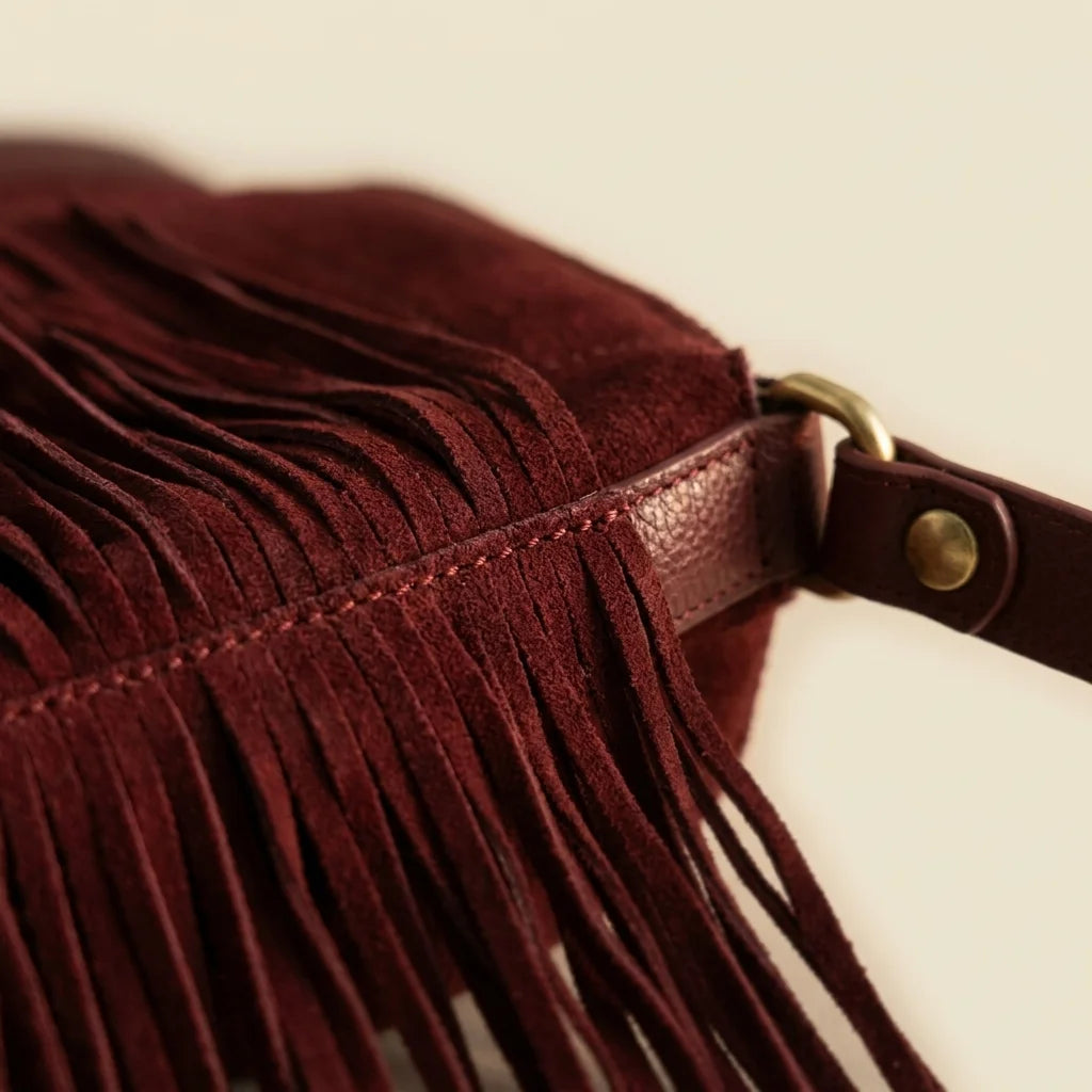 Close-up of fringe stitching and texture on Red cowhide bag with fringe