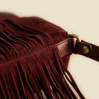 Close-up of fringe stitching and texture on Red cowhide bag with fringe