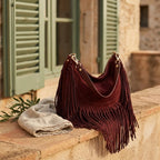 Red cowhide bag with fringe styled in a warm Mediterranean setting