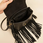 Interior lining and pockets of Black cowhide crossbody bag with fringe