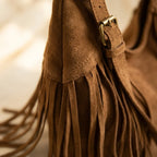 Close-up of fringe stitching and texture on Brown dark brown suede fringe bag