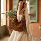 Woman wearing Brown dark brown suede fringe bag with swaying fringe