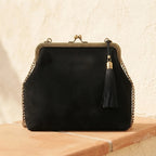 Back panel of Black designer black fringe bag with strap attachments