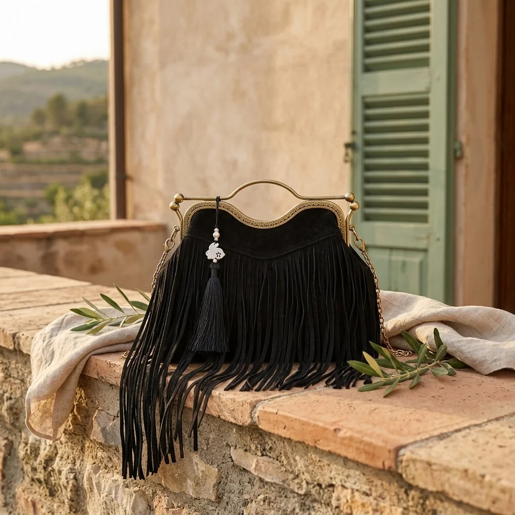 Black designer black fringe bag styled in a warm Mediterranean setting