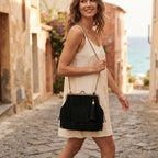 Woman wearing Black designer black fringe bag with swaying fringe