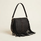 Black designer fringe crossbody bag, three-quarter angle showing side depth