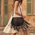Woman wearing Black designer fringe crossbody bag with swaying fringe