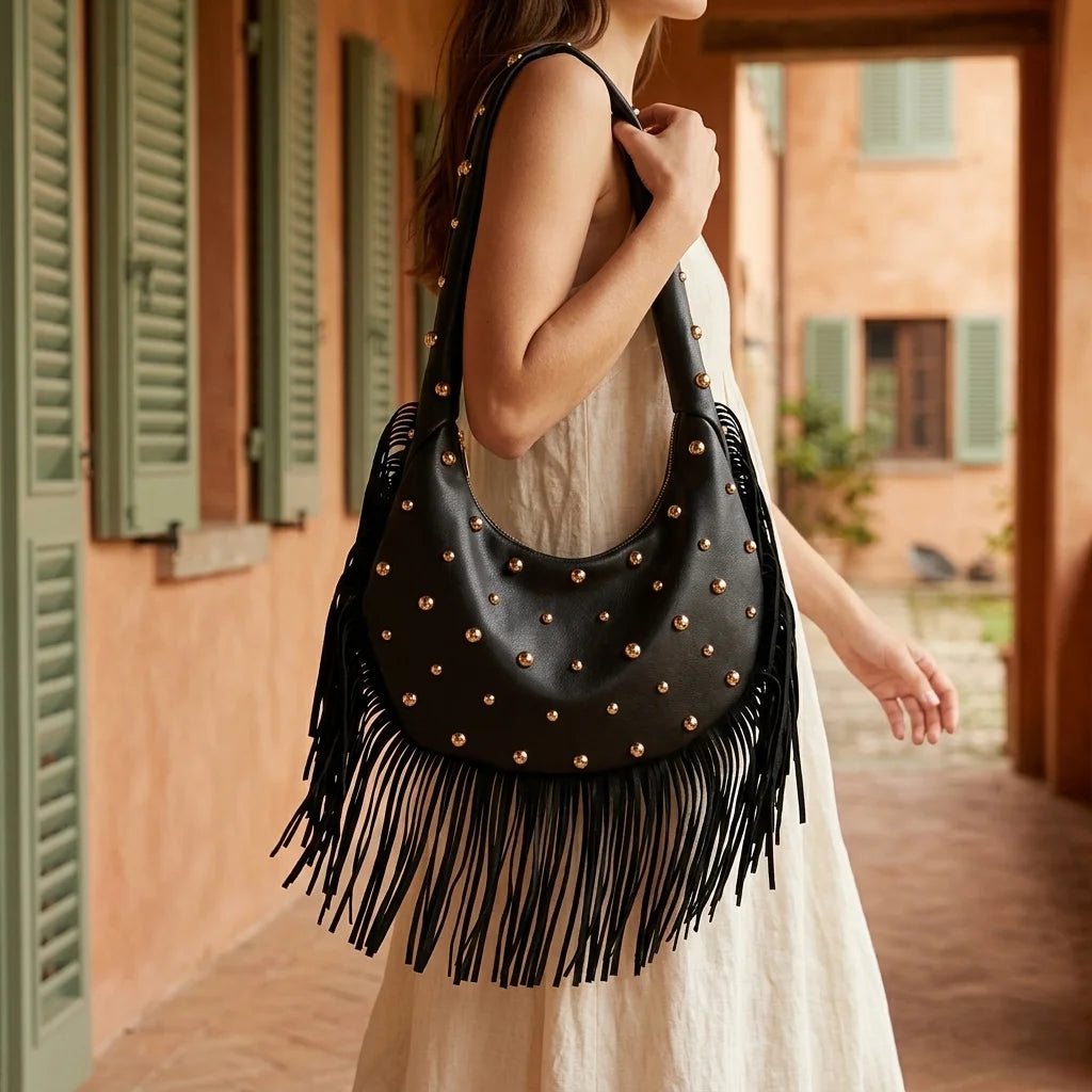 Woman wearing Black faux leather fringe hobo bag with swaying fringe