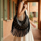 Woman wearing Black faux leather fringe hobo bag with swaying fringe
