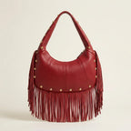 Back panel of Wine Red faux leather fringe hobo bag with strap attachments