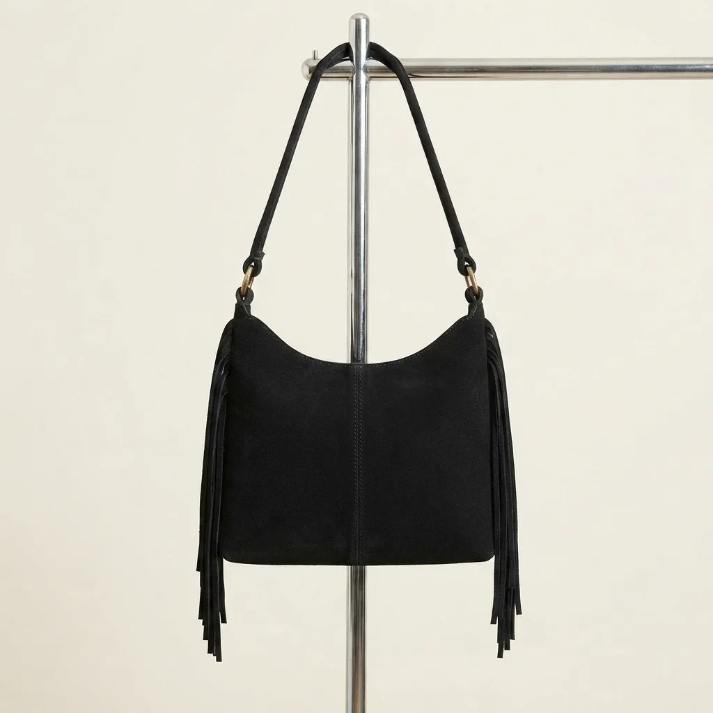 Back panel of Black faux suede fringe bag with strap attachments