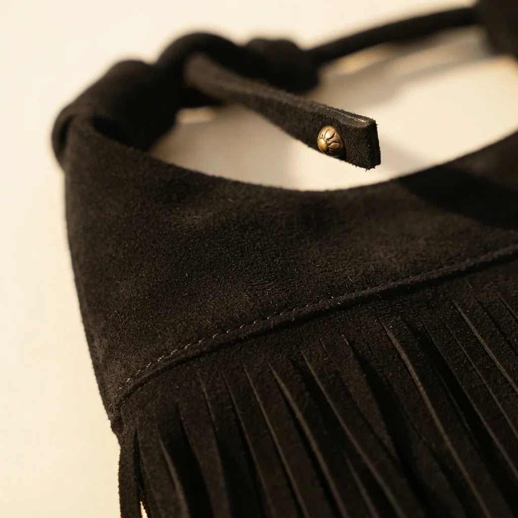 Close-up of fringe stitching and texture on Black faux suede fringe bag