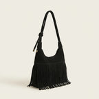 Black faux suede fringe bag, three-quarter angle showing side depth