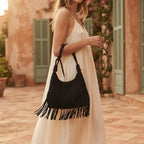 Woman wearing Black faux suede fringe bag with swaying fringe
