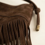 Close-up of fringe stitching and texture on Brown faux suede fringe bag
