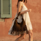 Woman wearing Brown faux suede fringe bag with swaying fringe
