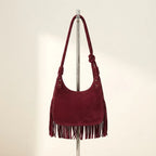 Back panel of Burgundy faux suede fringe bag with strap attachments