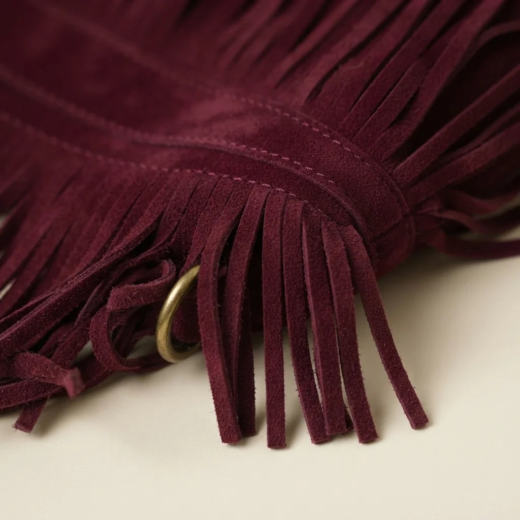 Close-up of fringe stitching and texture on Burgundy faux suede fringe bag