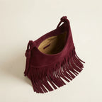 Interior lining and pockets of Burgundy faux suede fringe bag