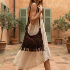 Woman wearing Coffee faux suede fringe bag with swaying fringe