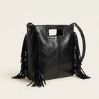 Black fringe backpack shoulder bag, three-quarter angle showing side depth