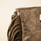 Close-up of fringe stitching and texture on Champagne fringe backpack shoulder bag