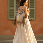 Woman wearing Champagne fringe backpack shoulder bag with swaying fringe