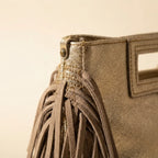 Close-up of fringe stitching and texture on Gold fringe backpack shoulder bag