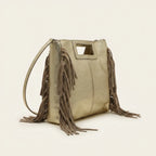 Gold fringe backpack shoulder bag, three-quarter angle showing side depth
