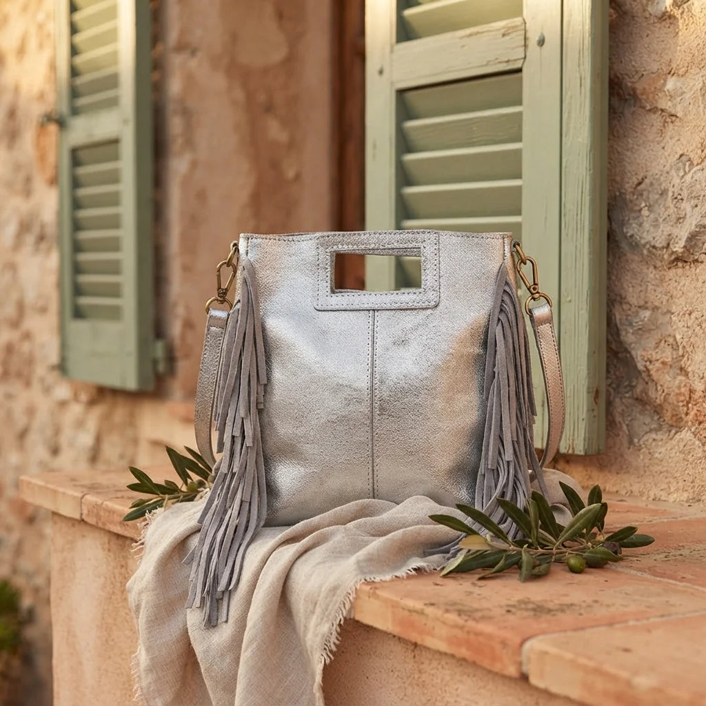Silver fringe backpack shoulder bag styled in a warm Mediterranean setting