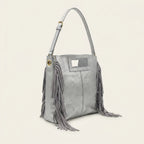 Silver fringe backpack shoulder bag, three-quarter angle showing side depth