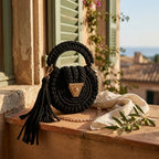 Black fringe bucket bag crossbody styled in a warm Mediterranean setting