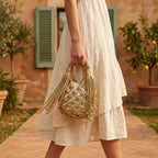 Woman wearing Gold fringe clutch bag designer with swaying fringe