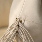 Close-up of fringe stitching and texture on White fringe clutch bag designer