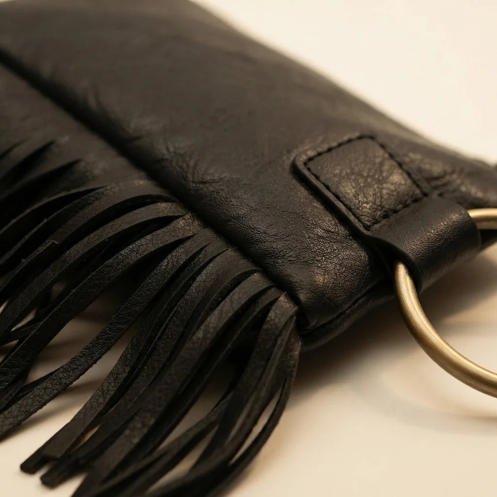 Close-up of fringe stitching and texture on Black fringe clutch bag leather