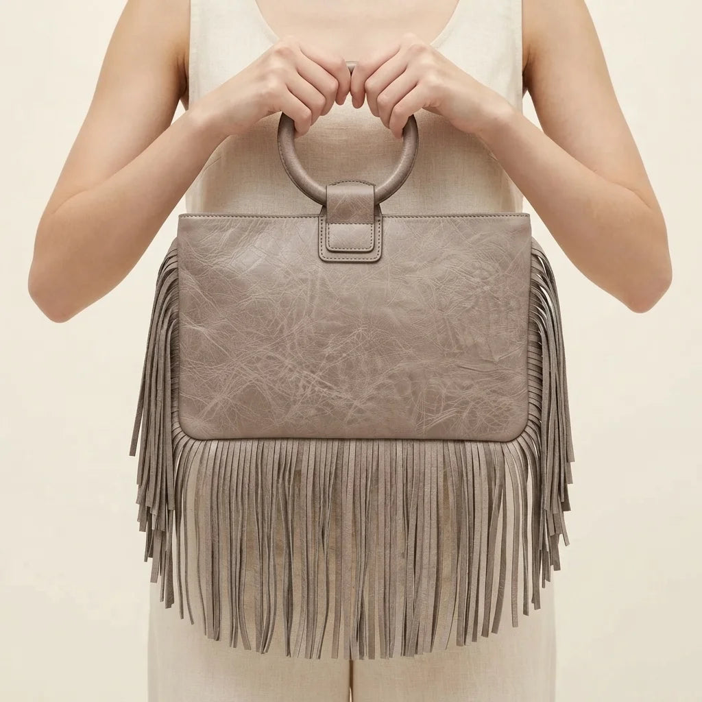 Back panel of Grey fringe clutch bag leather with strap attachments