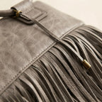 Close-up of fringe stitching and texture on Grey fringe clutch bag leather
