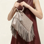 Grey fringe clutch bag leather, three-quarter angle showing side depth