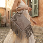 Woman wearing Grey fringe clutch bag leather with swaying fringe