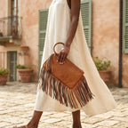 Woman wearing Khaki fringe clutch bag leather with swaying fringe