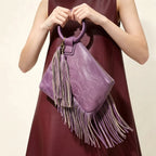 Purple fringe clutch bag leather, three-quarter angle showing side depth