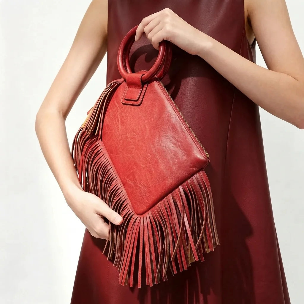 Red fringe clutch bag leather, three-quarter angle showing side depth