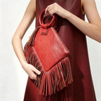Red fringe clutch bag leather, three-quarter angle showing side depth