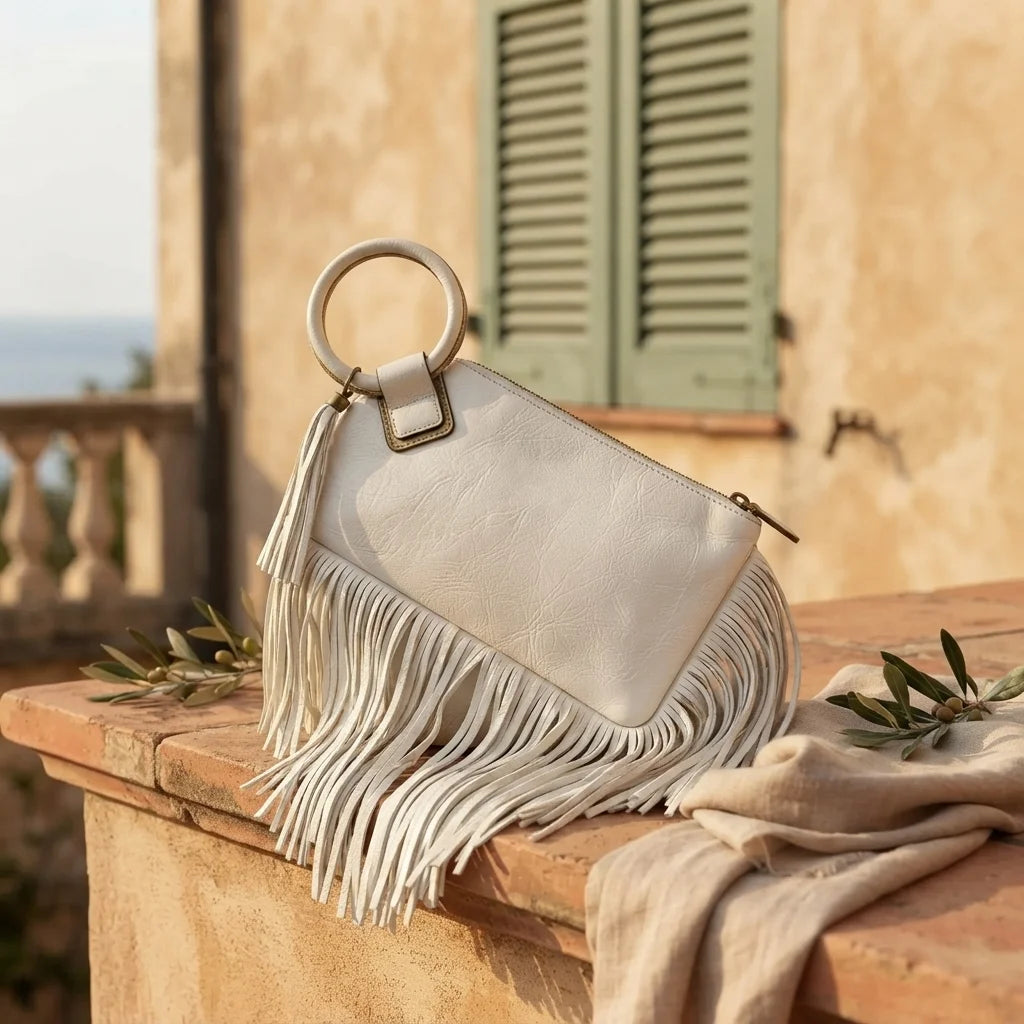 White fringe clutch bag leather styled in a warm Mediterranean setting