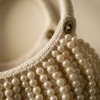 Close-up of fringe stitching and texture on Beige fringe evening bag