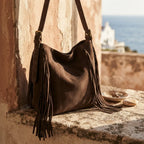 Brown fringe hobo shoulder bags styled in a warm Mediterranean setting