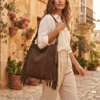 Woman wearing Brown fringe hobo shoulder bags with swaying fringe