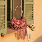 Floral fringe messenger bag styled in a warm Mediterranean setting