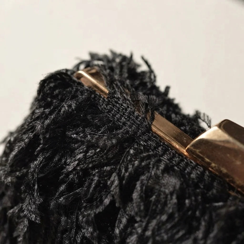 Close-up of fringe stitching and texture on Black fringe mini bag