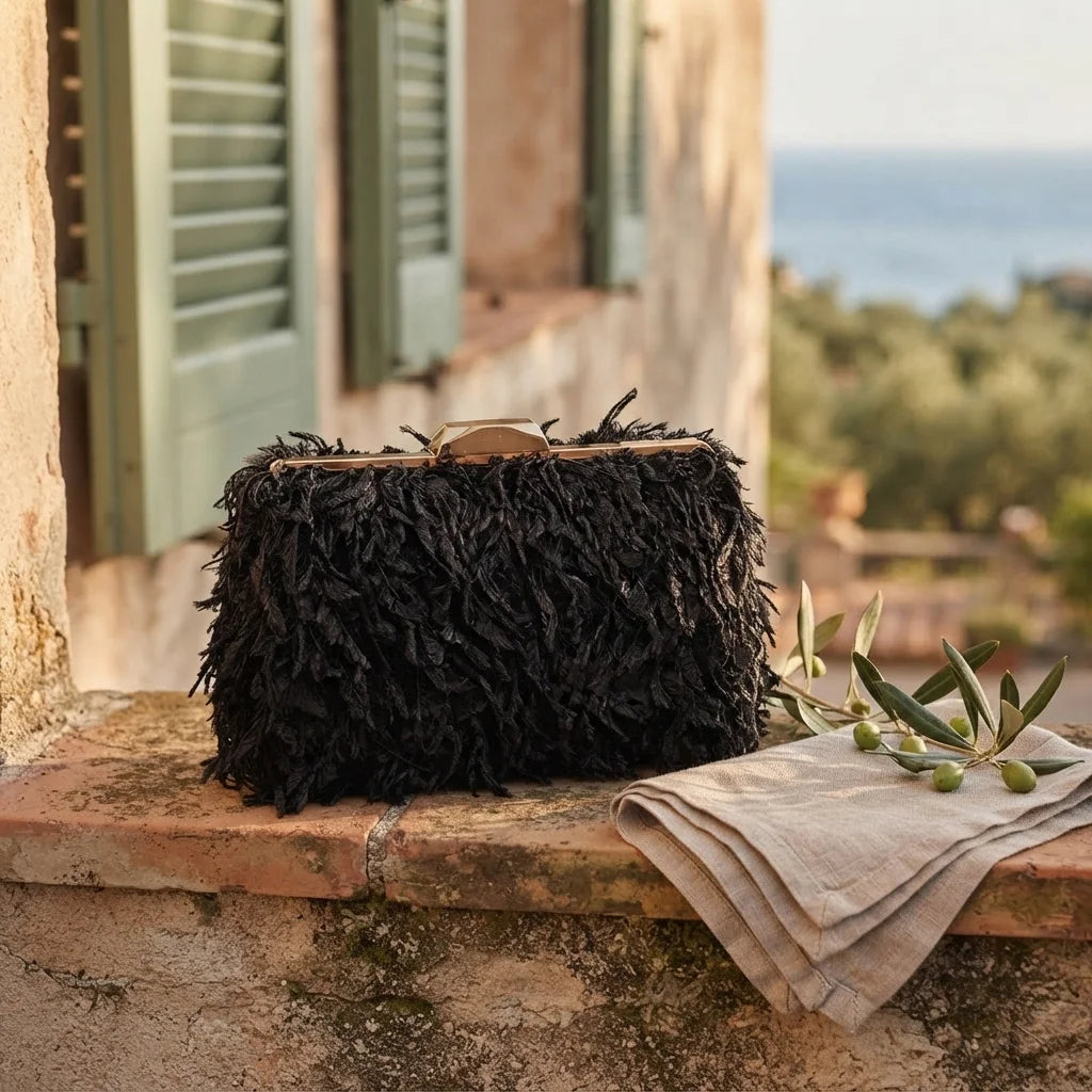 Black fringe mini bag styled in a warm Mediterranean setting